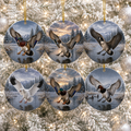 Six round ceramic Christmas ornaments featuring different waterfowl duck and geese scenes, hanging on a snowy Christmas tree branch.
