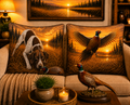 Decorative pillows with hunting-themed designs on a couch, featuring a sunset over a field with a German Shorthair Pointer and Pheasant