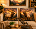 Two throw pillows with high plains elk designs on a couch in a living room setting.